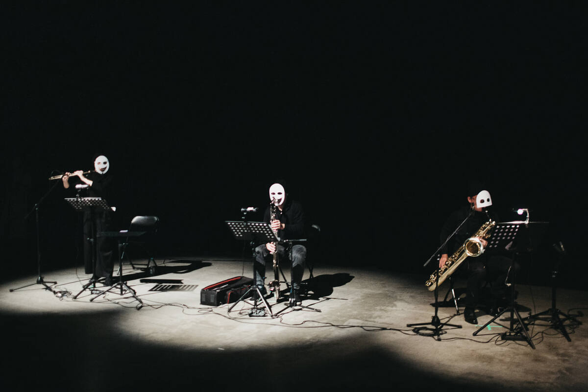 The Bunker. Fake Opera — masked instrumentalists in a pool of light