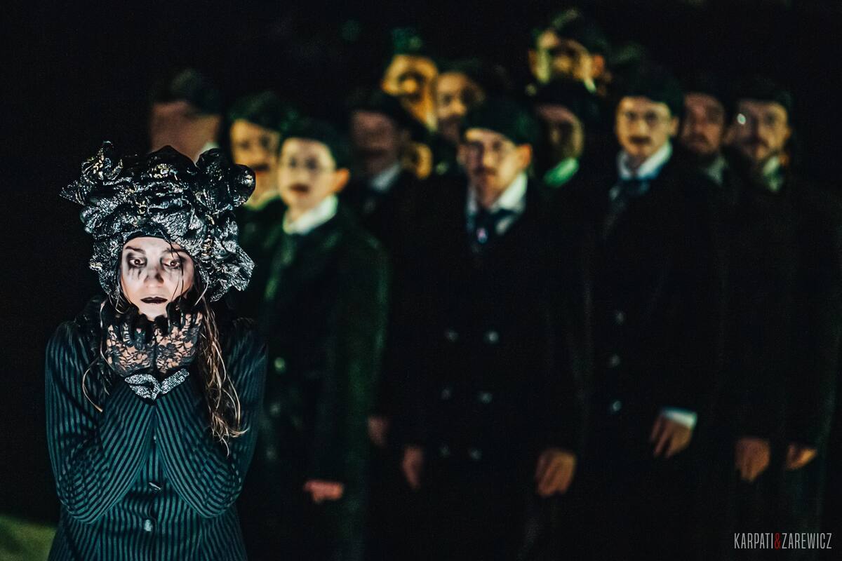 The Night of Ravens — masked chorus in green light