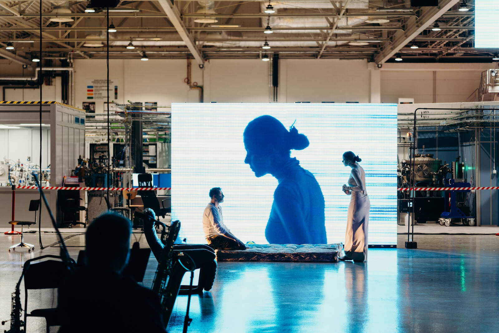 Solaris — performers and musicians in the illuminated hall of the SOLARIS synchrotron